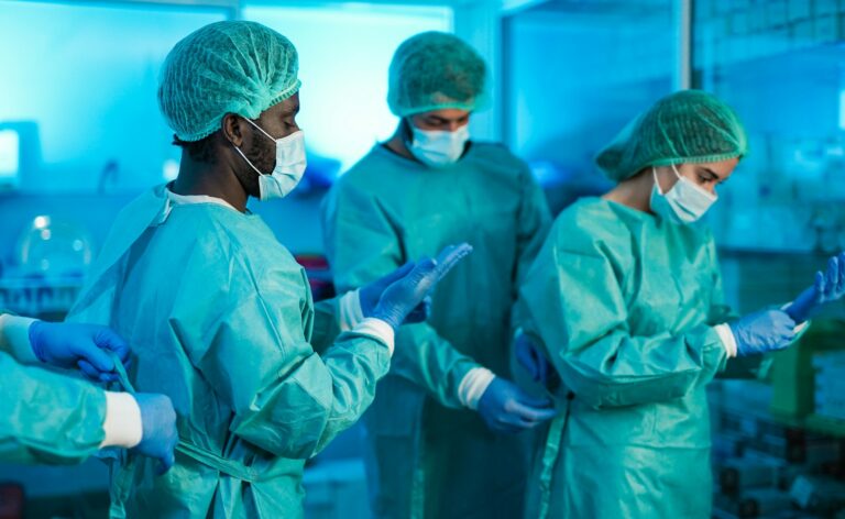 Doctors and nurse preparing and getting dressed to work inside hospital
